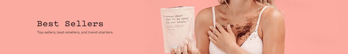 Best Sellers category banner: a woman in a cream bra with coffee scrub across her chest holding a frank body Original Coffee Scrub pouch. Text reads: Best Sellers. Top-sellers, best-smellers, and trend-starters.