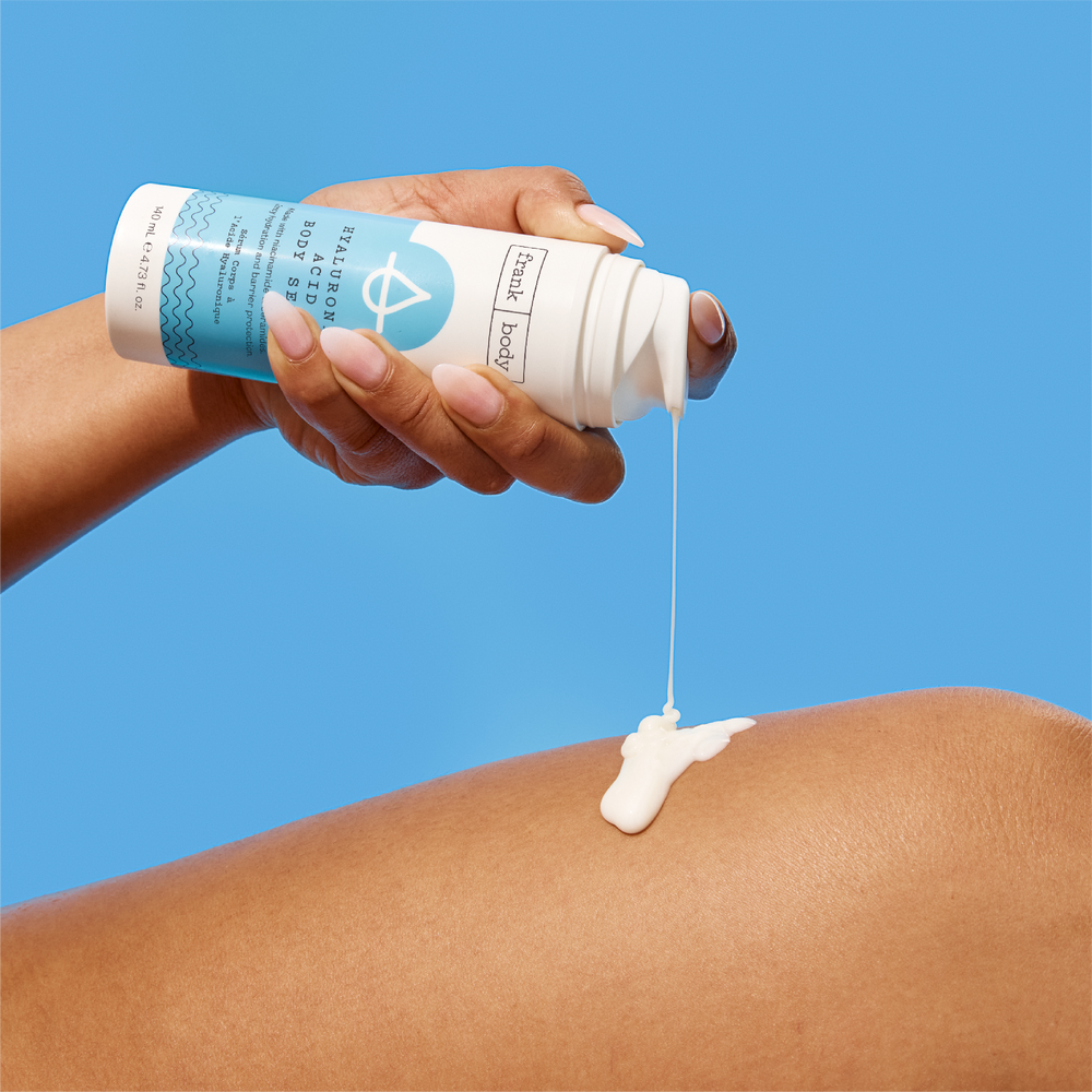 A white and blue bottle of frank body Hyaluronic Acid Body Serum, 140ml.