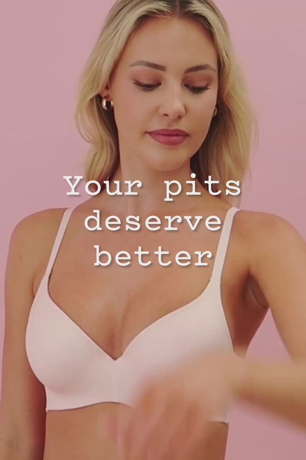 frank body Caffeine Deodorant film: a blonde woman in a pale pink bra applying deodorant to her underarm. Text reads: Your pits deserve better.