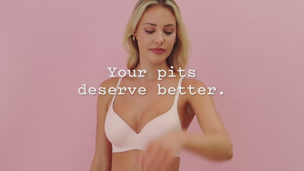 frank body Caffeine Deodorant film: a blonde woman in a pale pink bra applying deodorant to her underarm. Text reads: Your pits deserve better.