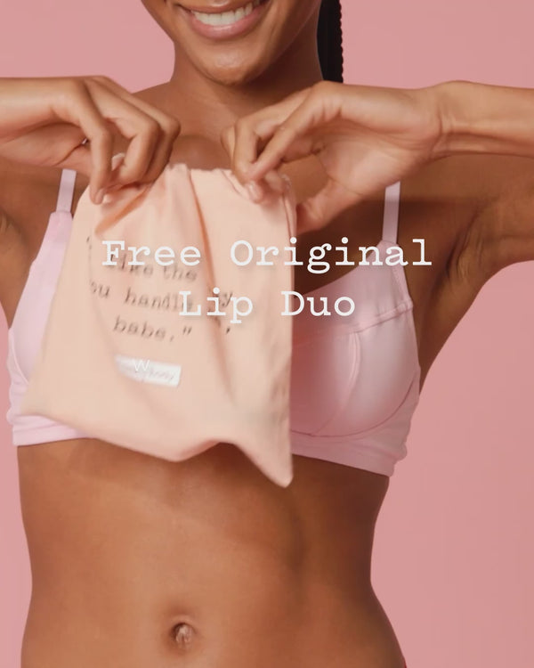 frank body gift with purchase film: a woman holding a pink frank body pouch. Text reads: Free Original Lip Duo.